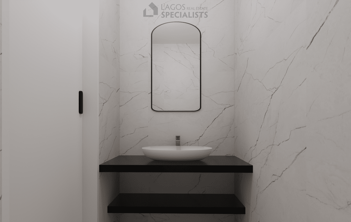 guest bathroom with modern sink and marble-effect walls in 2-bedroom Lagos apartment