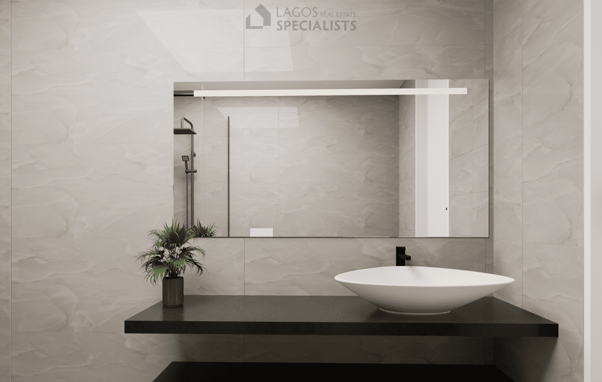 guest bathroom with modern sink and marble-effect walls in 2-bedroom Lagos apartment