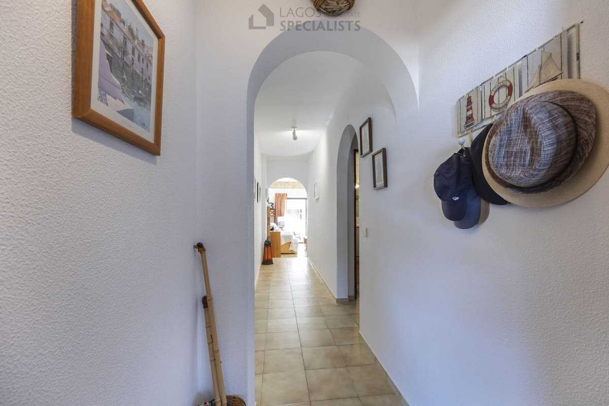 Bright entrance hallway with archways, hat hooks and tiled floor leading toward the living room in Iberlagos, Lagos