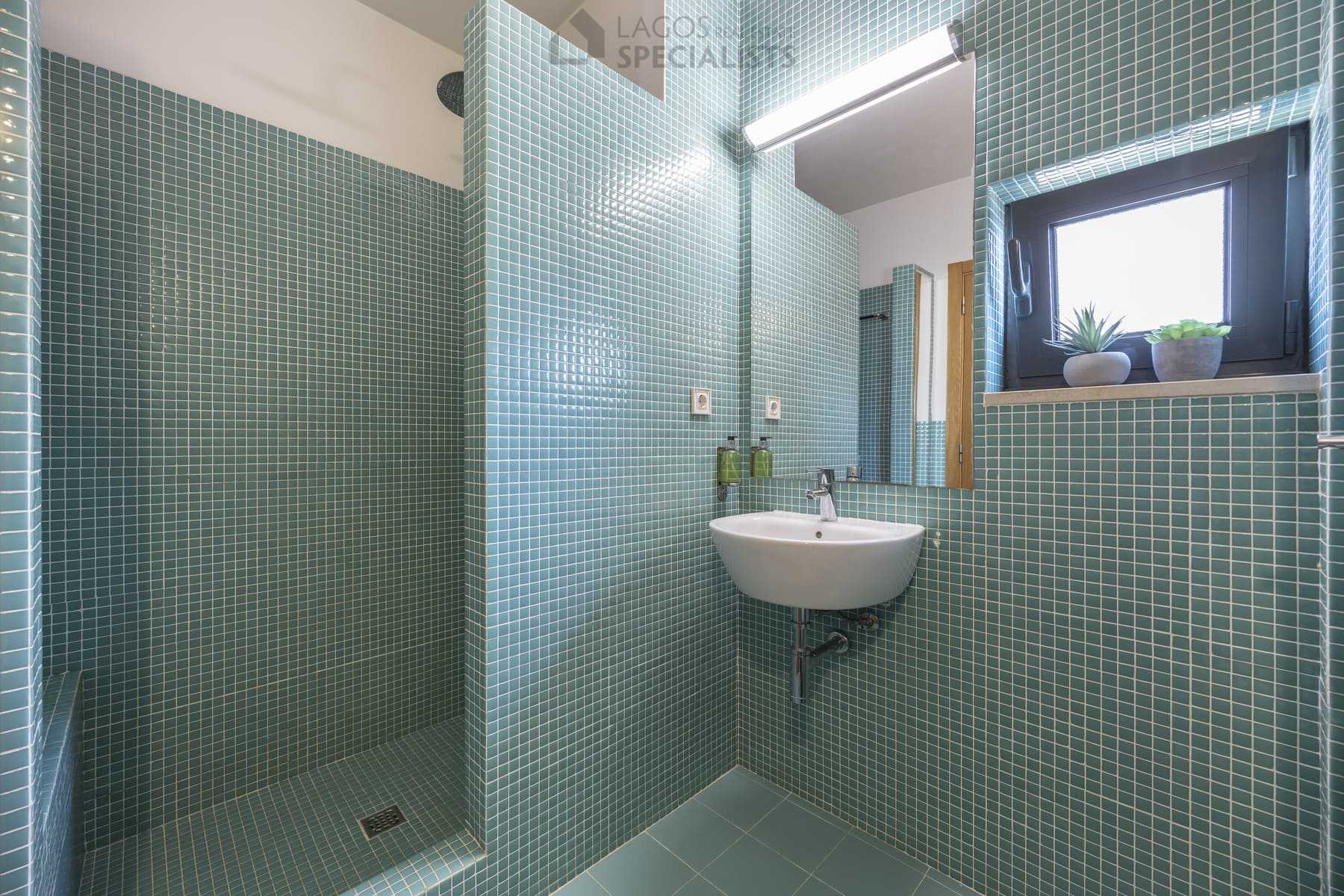 Bathroom with teal mosaic tiles and walk-in shower, Lagos property