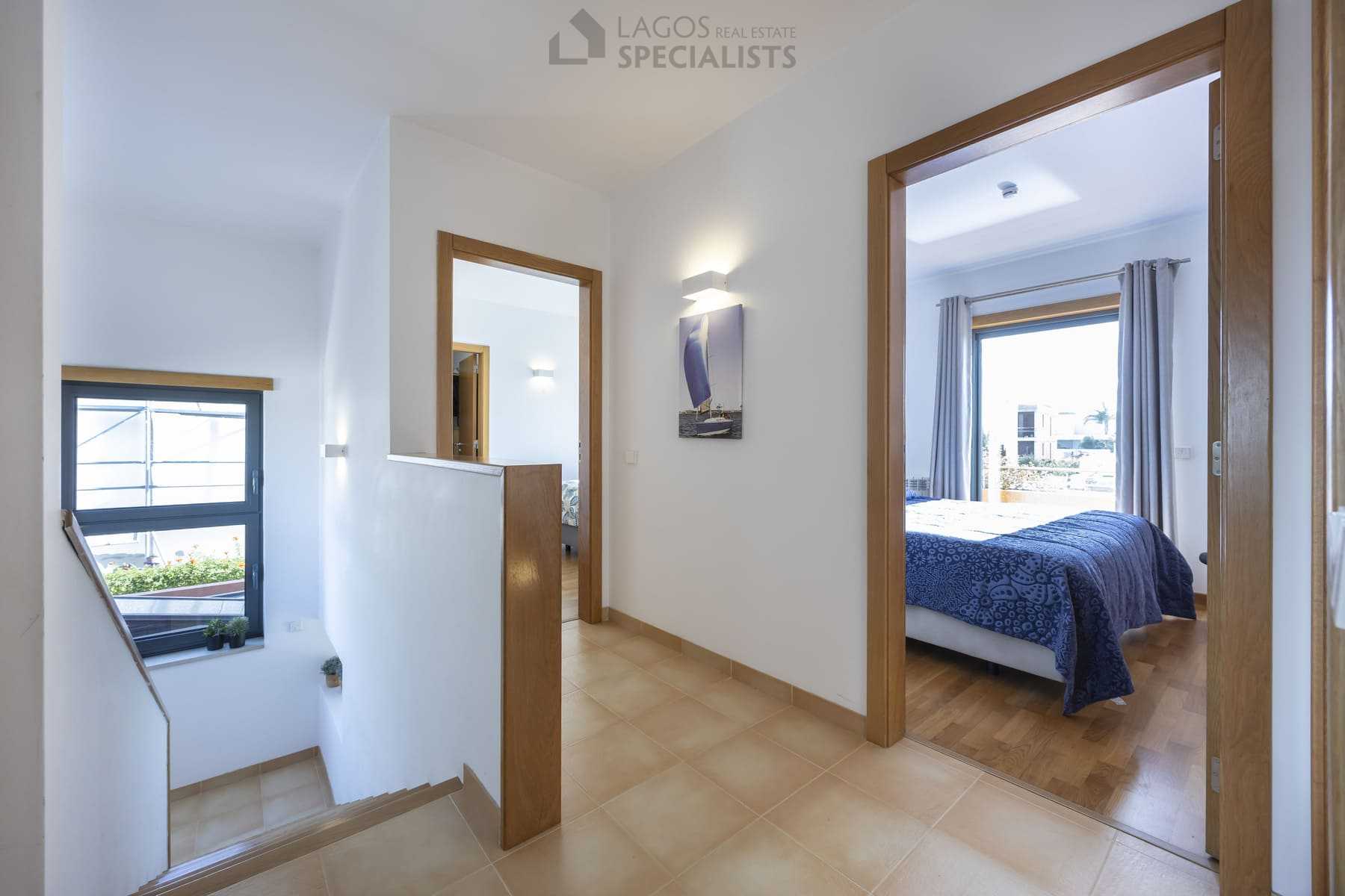 Upstairs hallway connecting bedrooms with natural light, Lagos villa