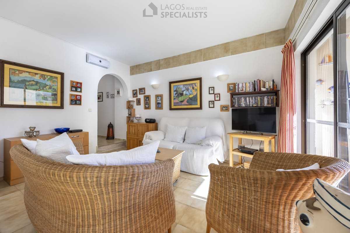 Living room with wicker sofas, artwork and terrace doors - Iberlagos apartment, Lagos