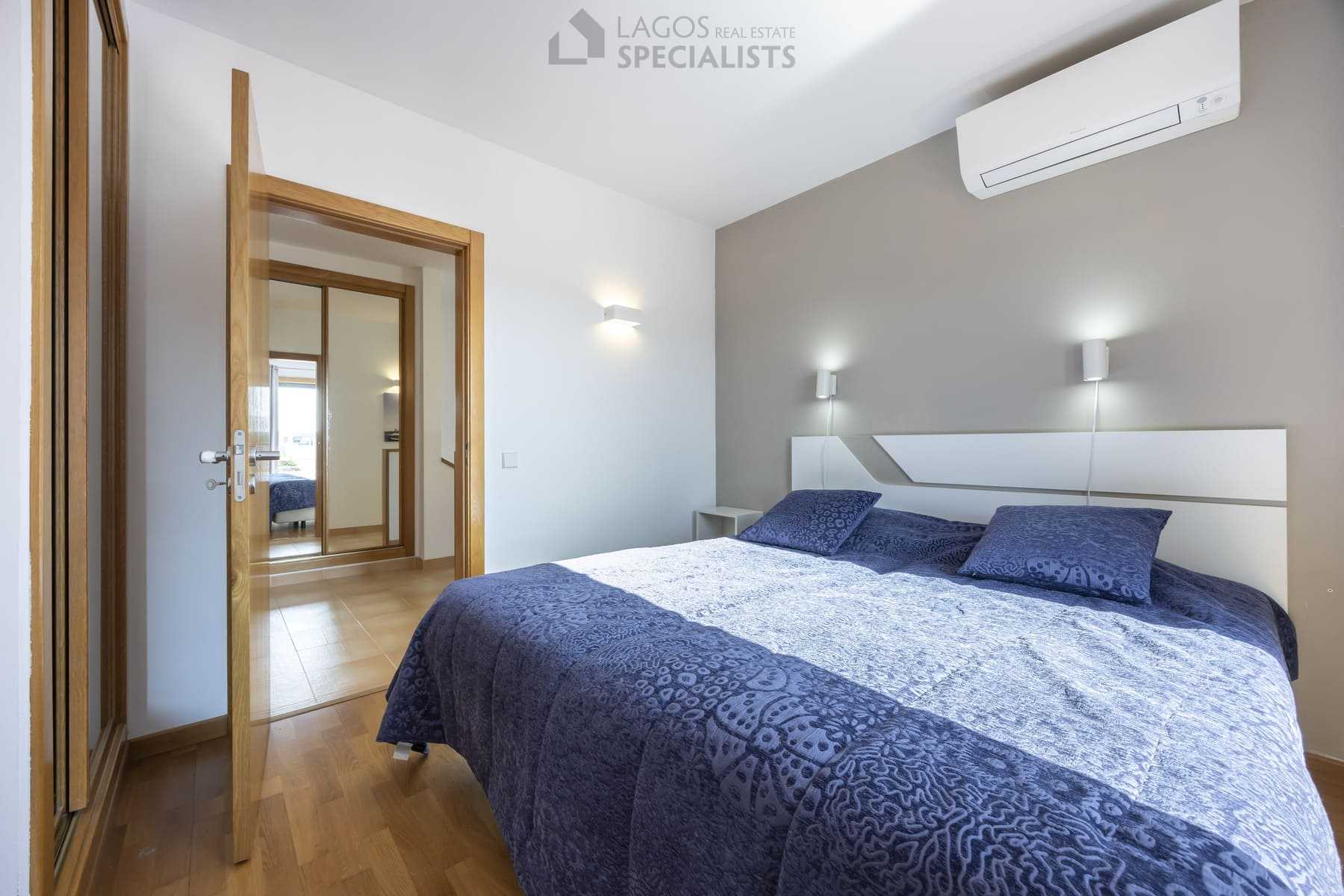 Stylish bedroom interior with patterned duvet and natural light, Lagos property