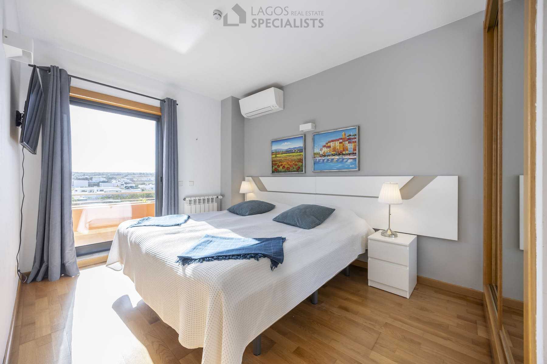 Elegant bedroom with neutral tones and wood accents in Algarve villa