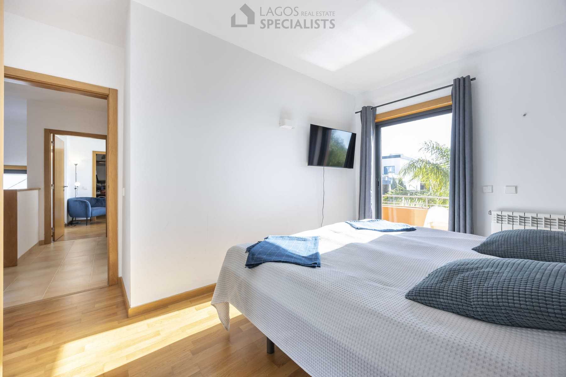 Master bedroom with soft lighting and balcony view, Lagos Portugal