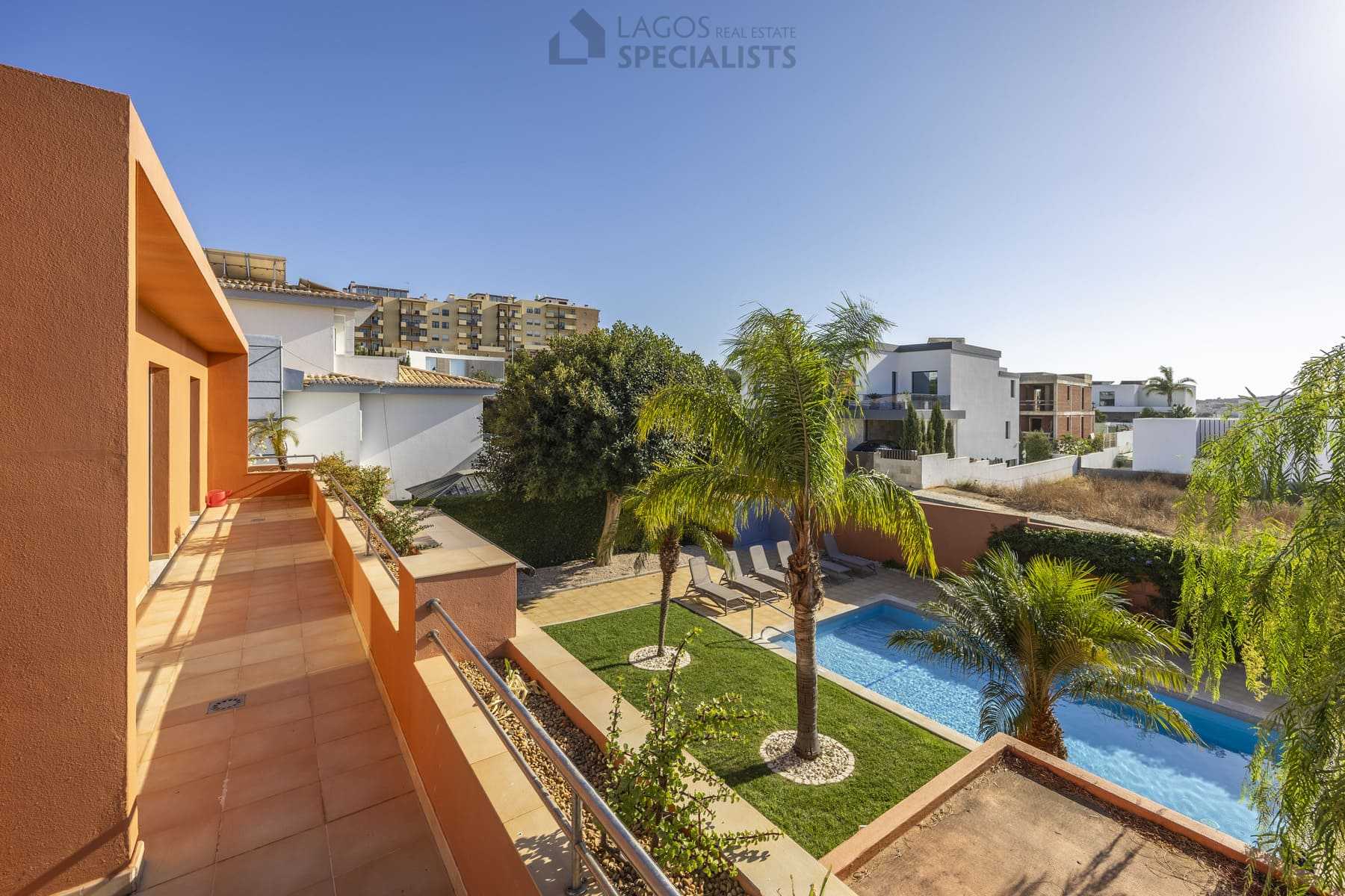 Balcony overlooking pool and palm trees, Algarve property