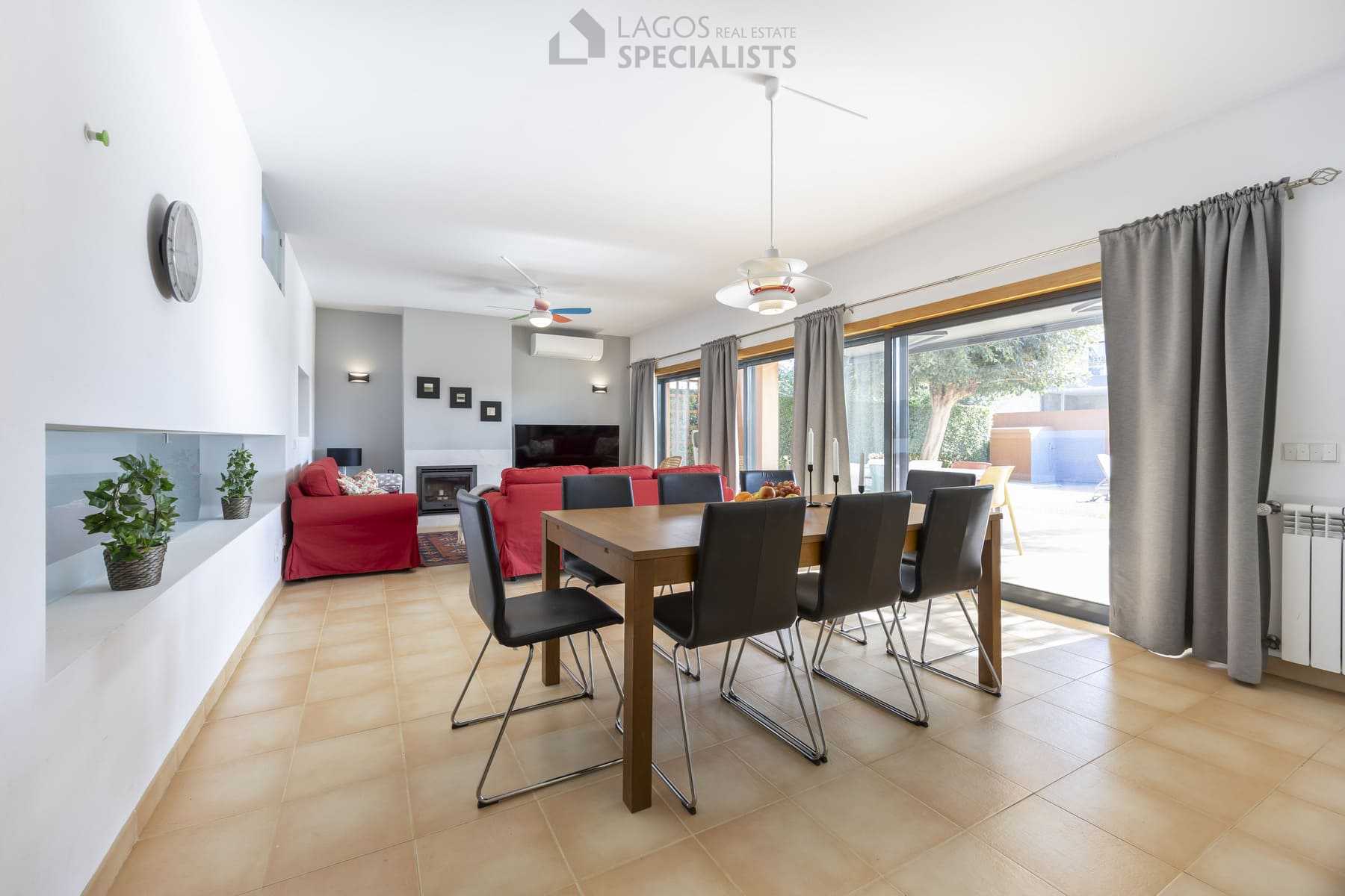 Dining room with large windows and view to pool area, Lagos home