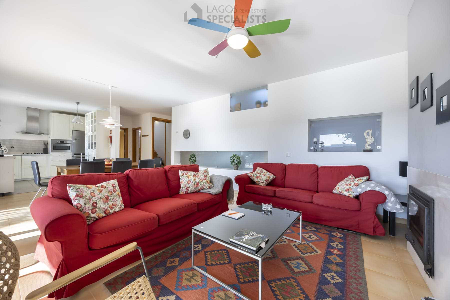 Colourful living room with red sofas and patterned rug, Algarve home