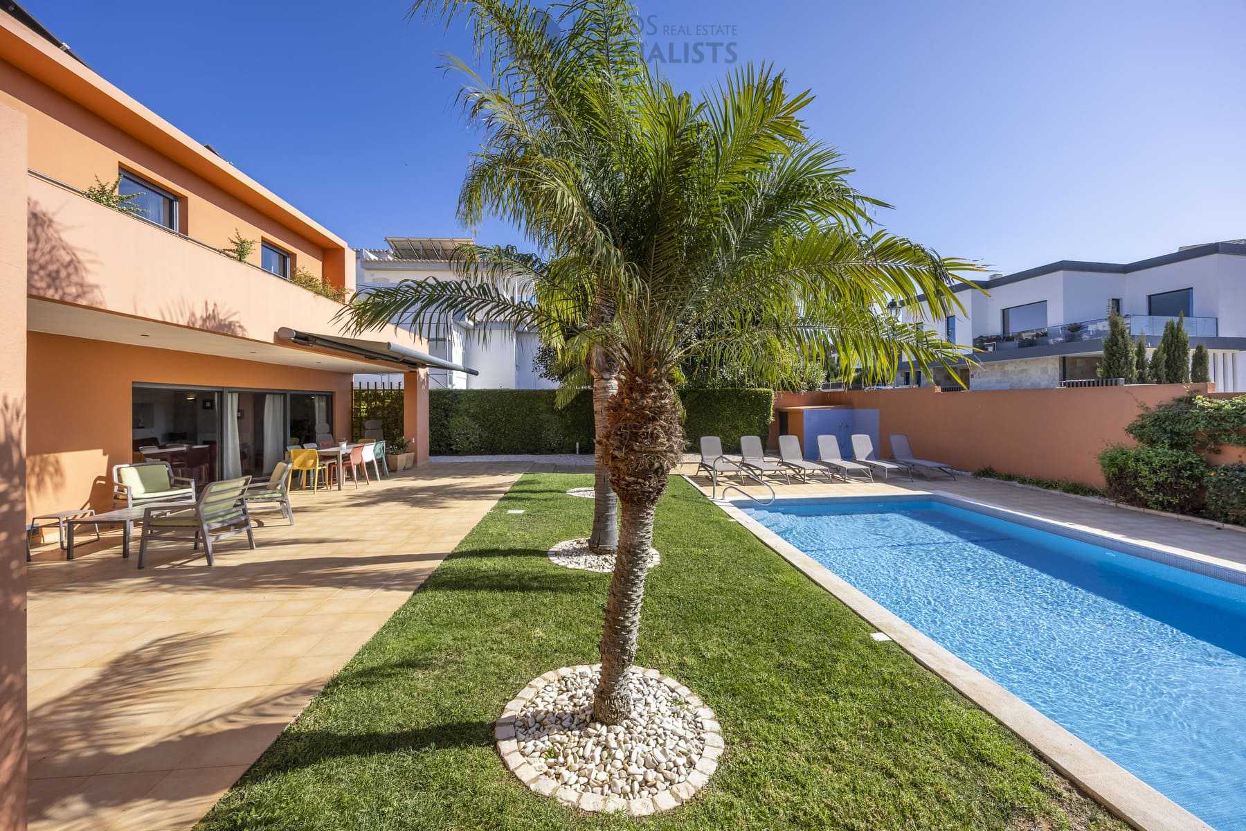 Palm trees by the terrace and pool of a modern villa in Lagos
