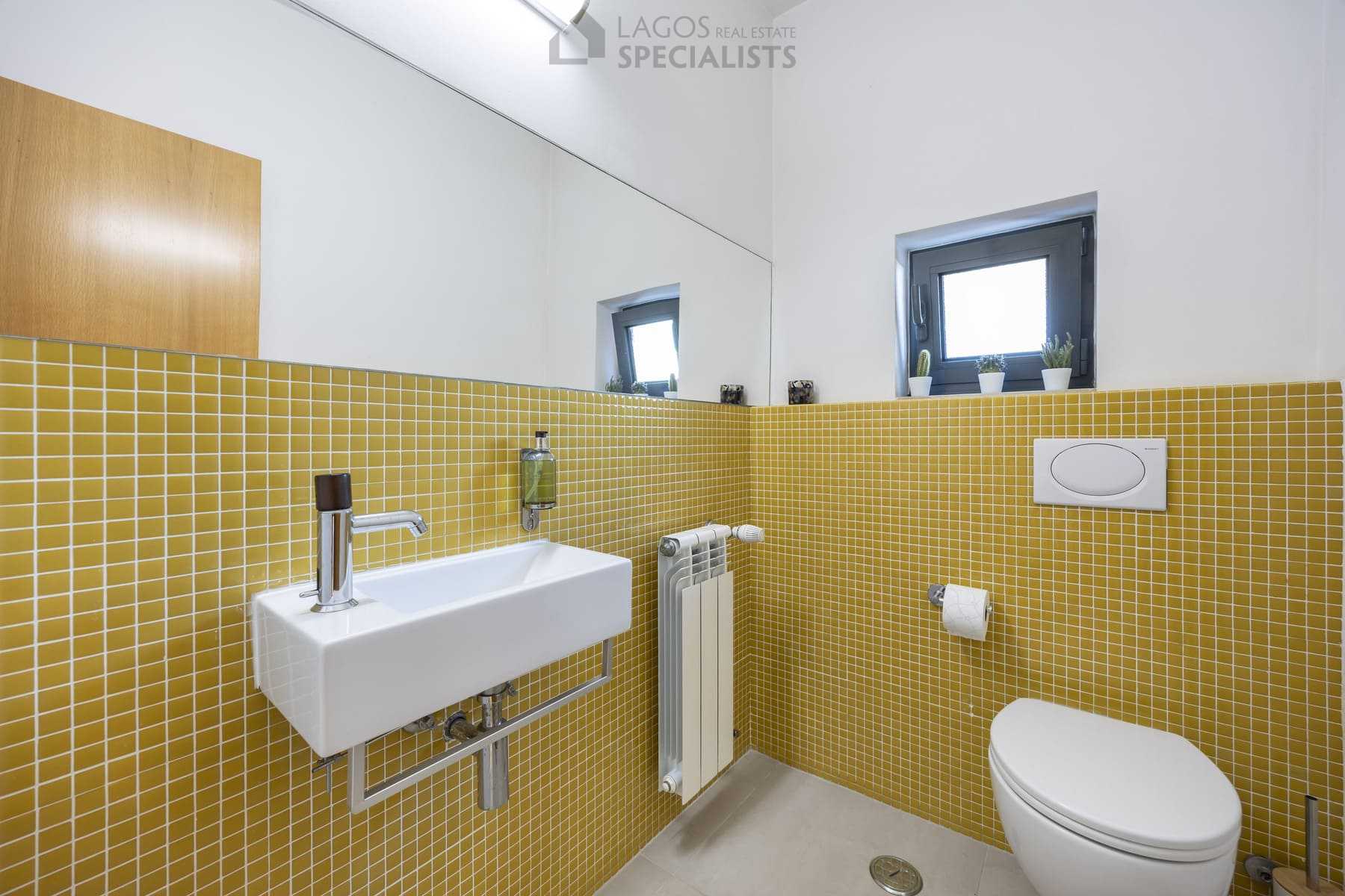 Guest bathroom with yellow mosaic tiles and modern fittings, Algarve property