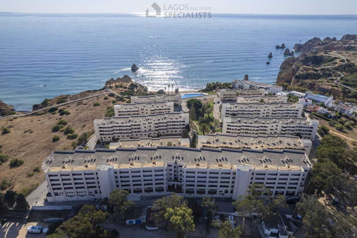 Aerial photo showing Iberlagos buildings and pool facing the Atlantic Ocean above Dona Ana Beach, Lagos