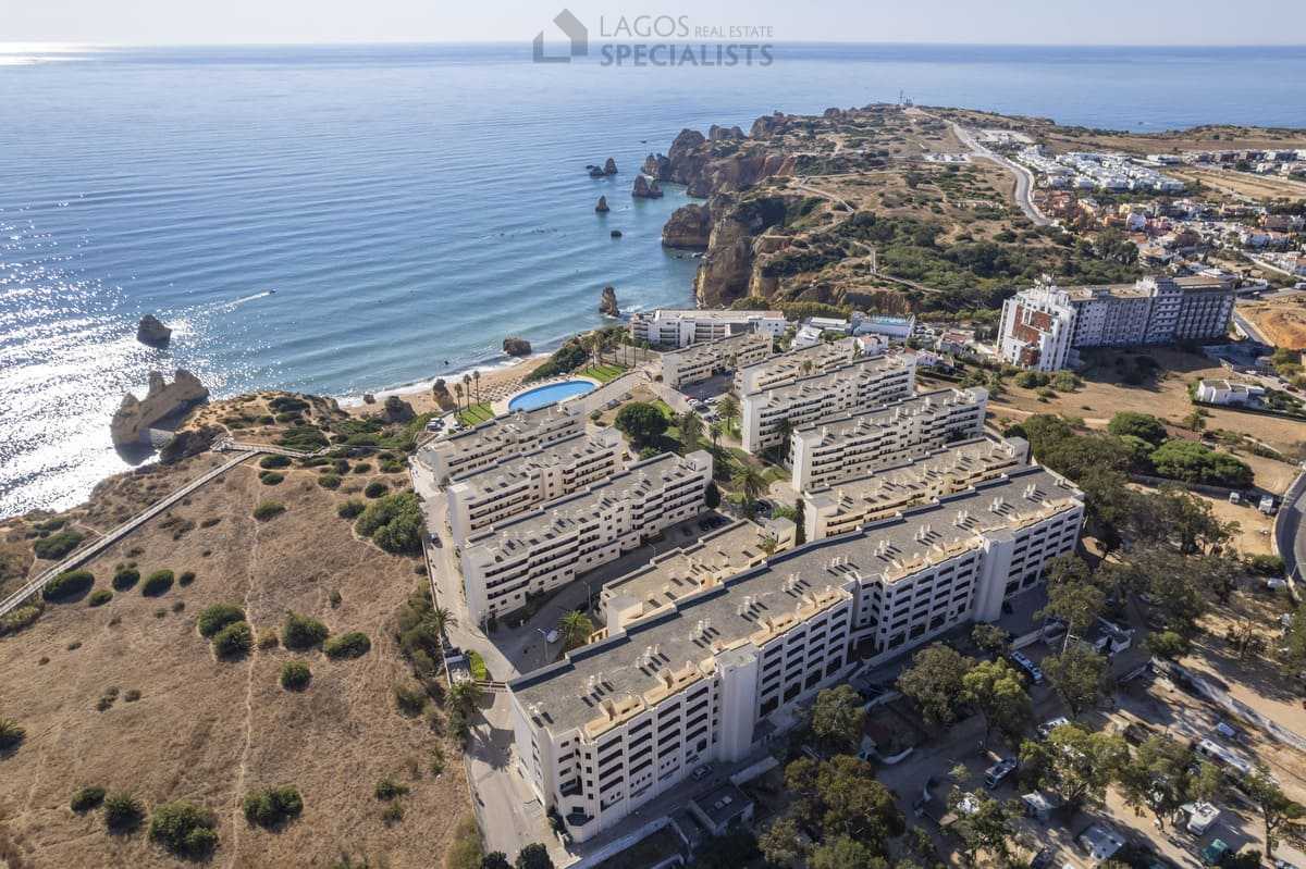 Aerial shot of Iberlagos apartments, pool and coastline near Dona Ana Beach, Lagos Algarve