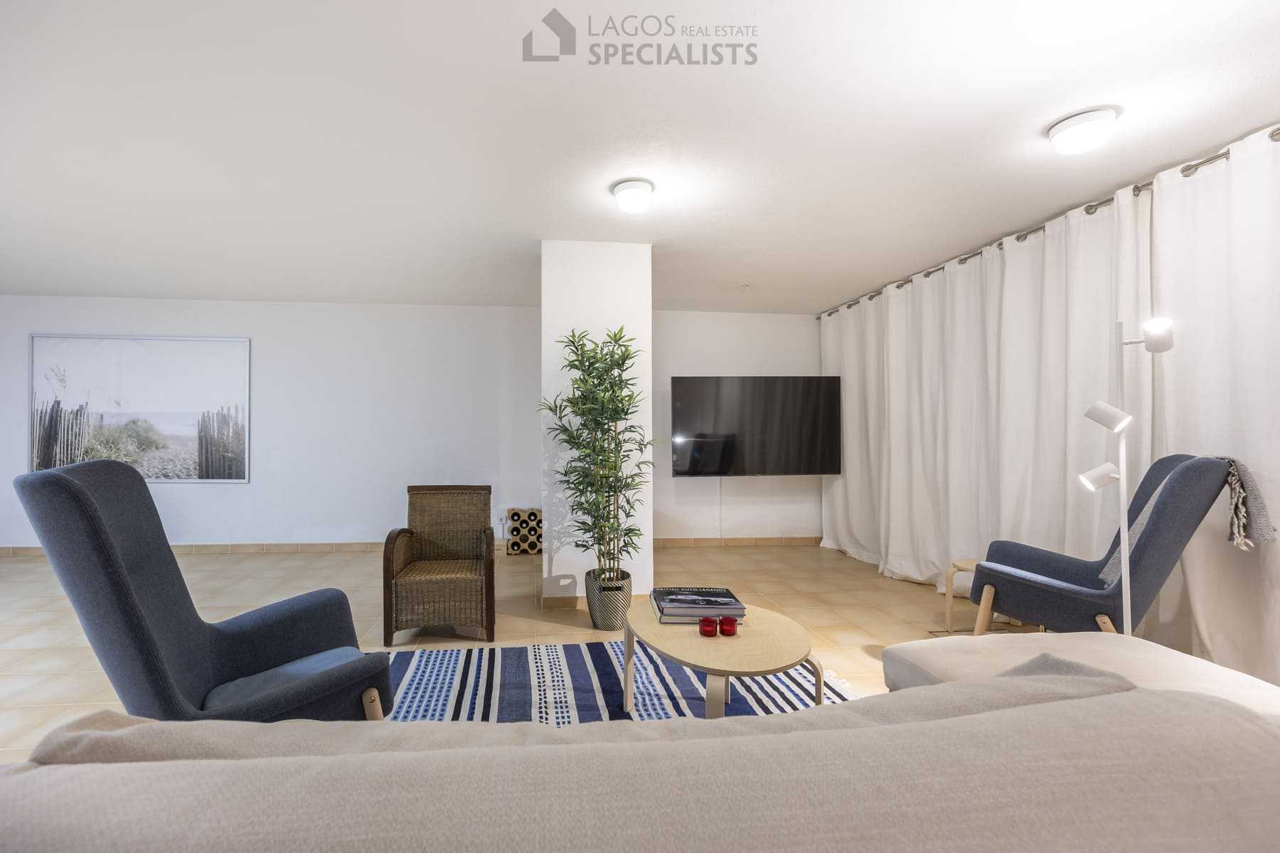 Spacious basement lounge with TV area and reading nook, Lagos villa