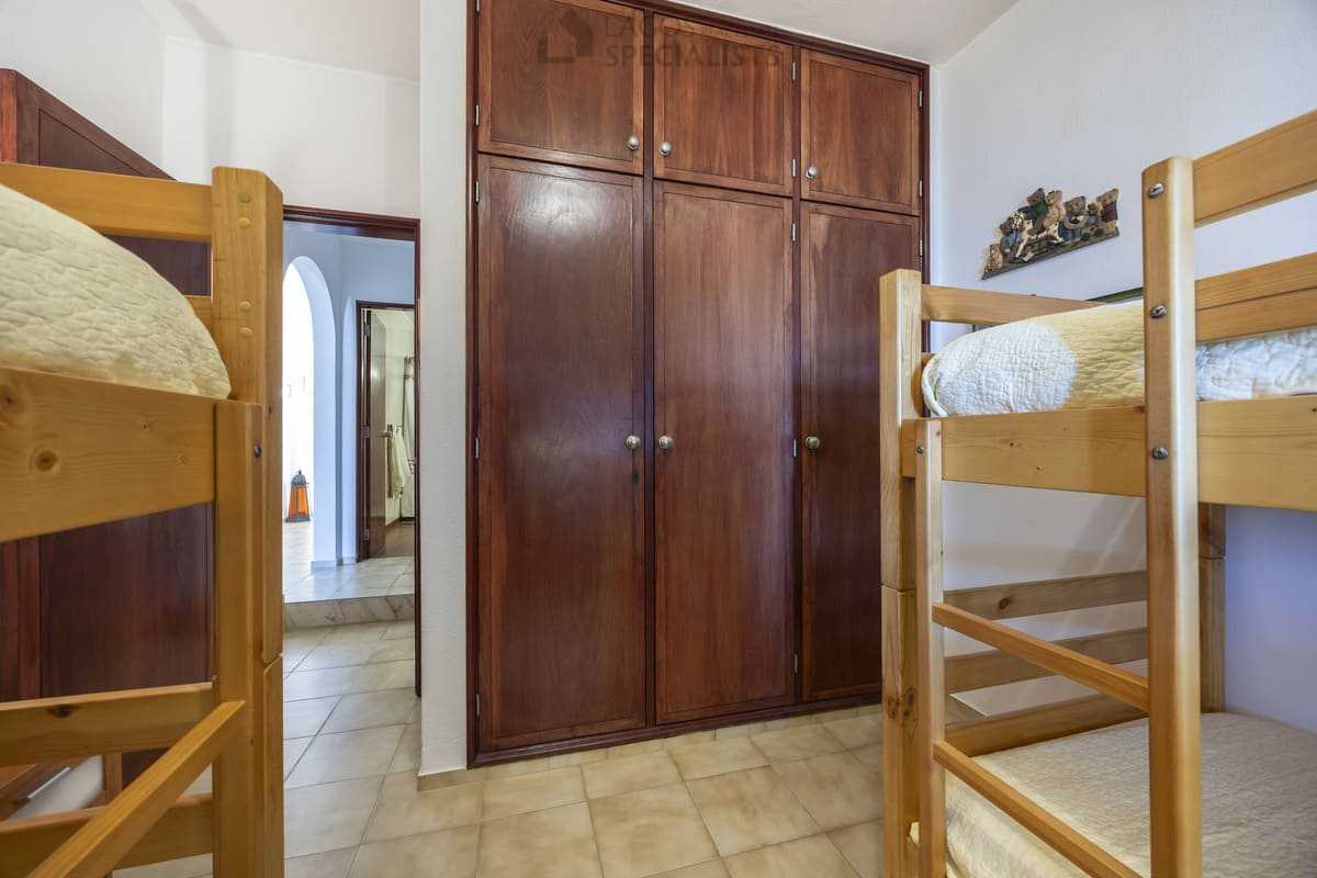 Wooden built-in wardrobes and bunk beds in the second bedroom of an Iberlagos apartment in Lagos