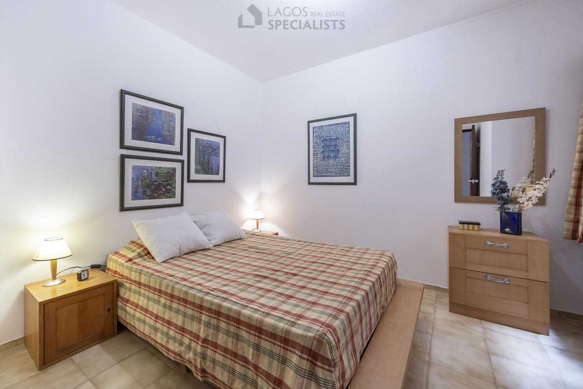 Peaceful double bedroom with bedside lamps and wall art in Iberlagos resort apartment, Lagos