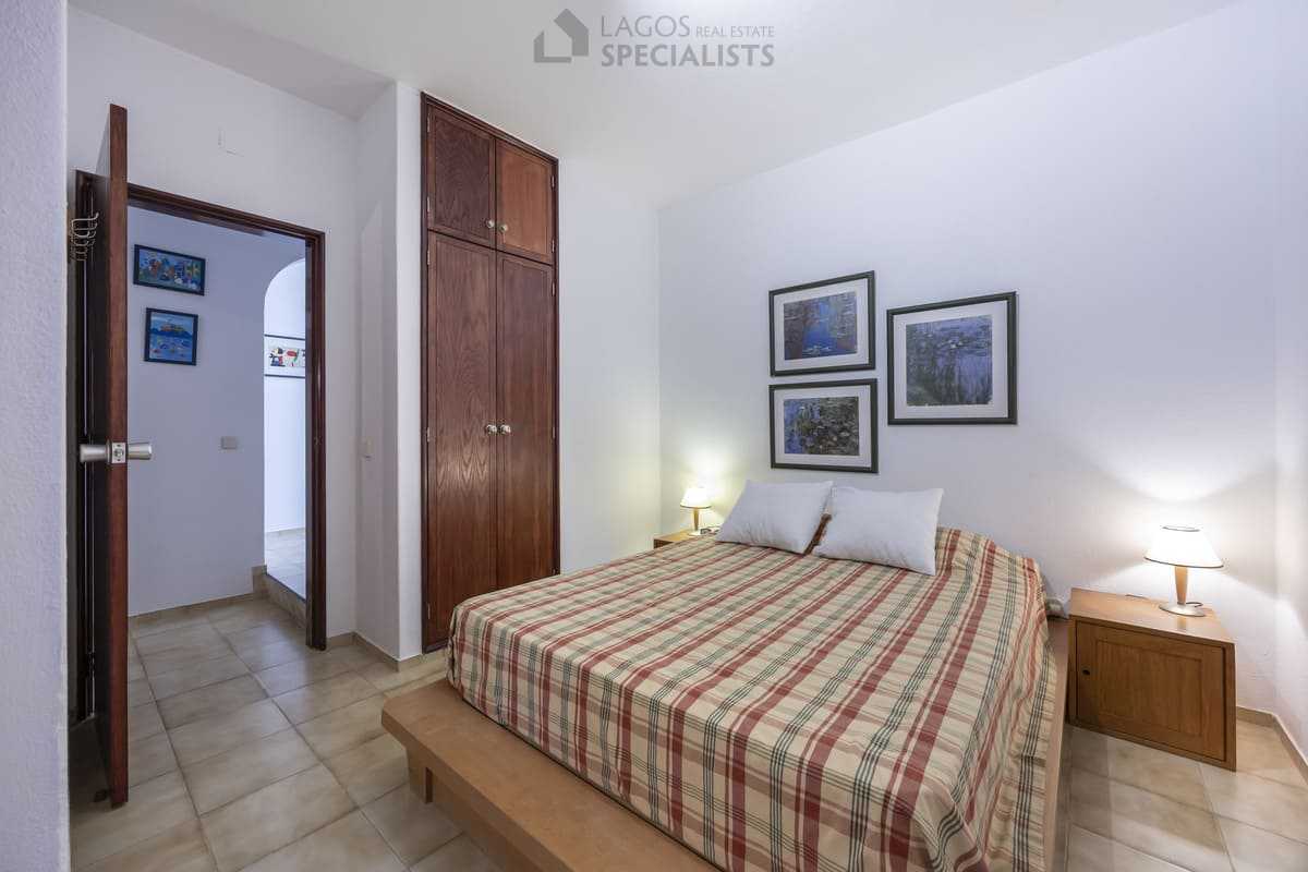 Double bedroom showing wooden wardrobe and tiled floors in Iberlagos apartment, Lagos