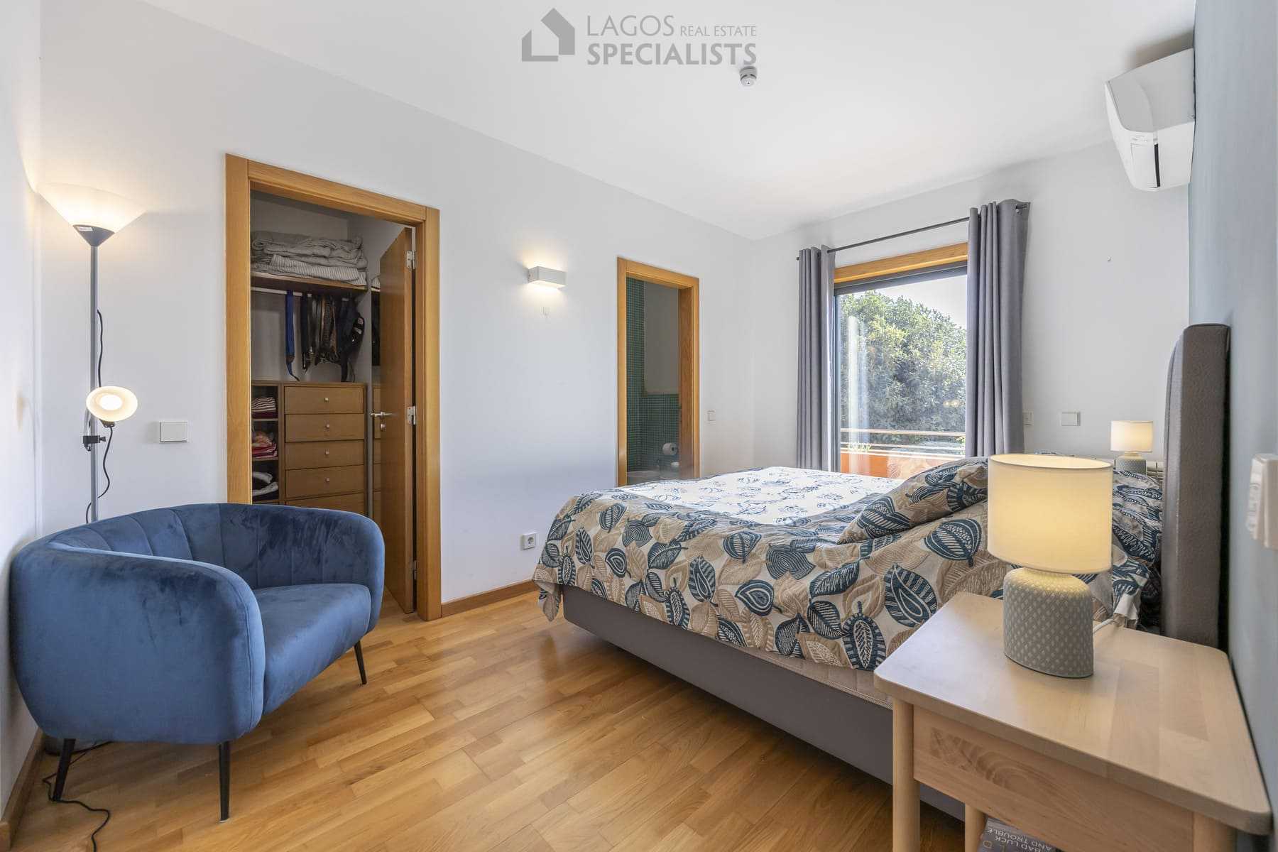 Cosy bedroom with walk-in closet and balcony access, Lagos home