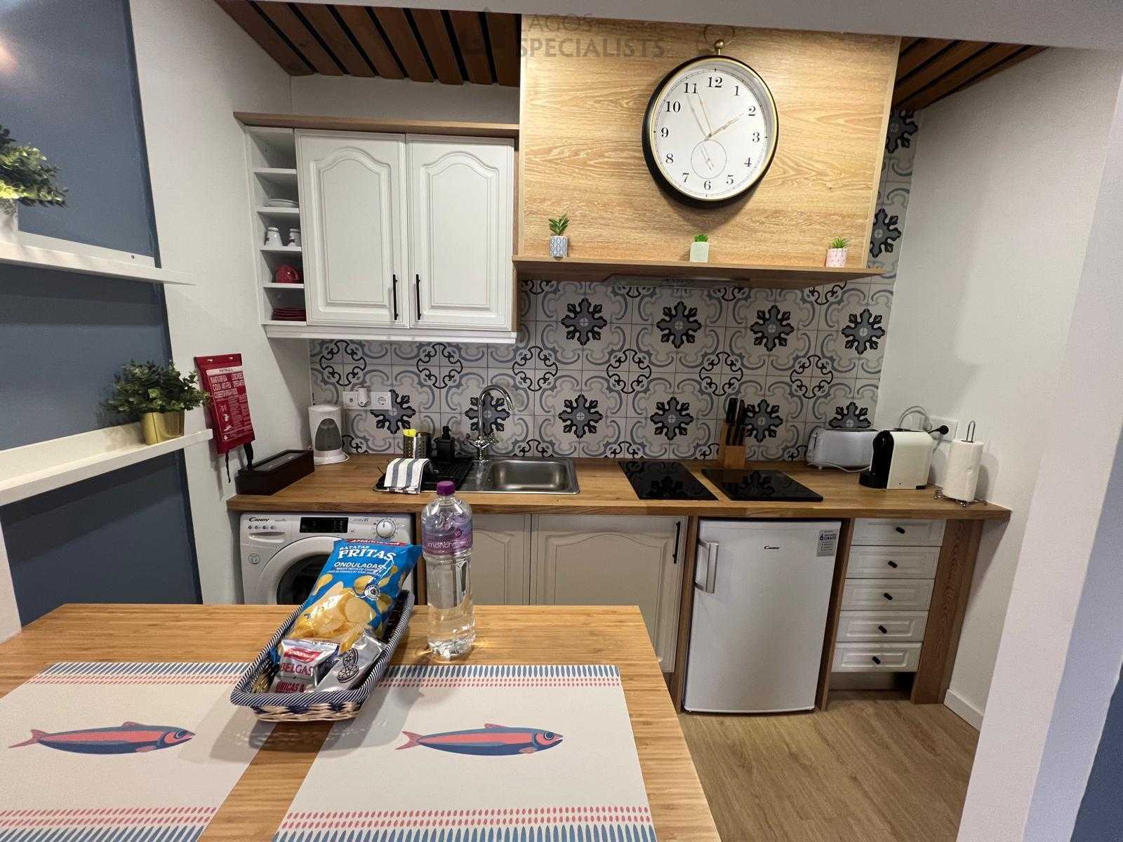 Fully equipped kitchen with wooden countertop and decorative tiles – Lagos property for sale