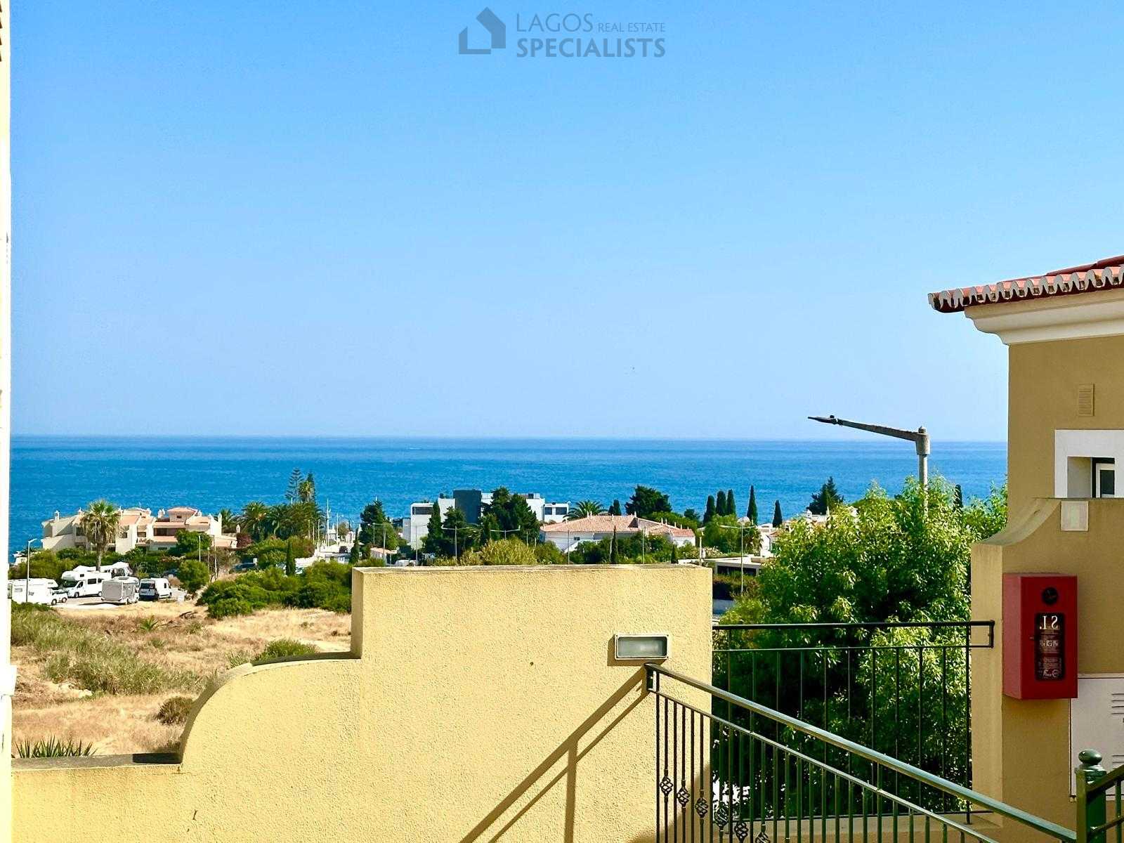 Balcony view overlooking the sea and nearby houses in Alporchinhos Porches Algarve
