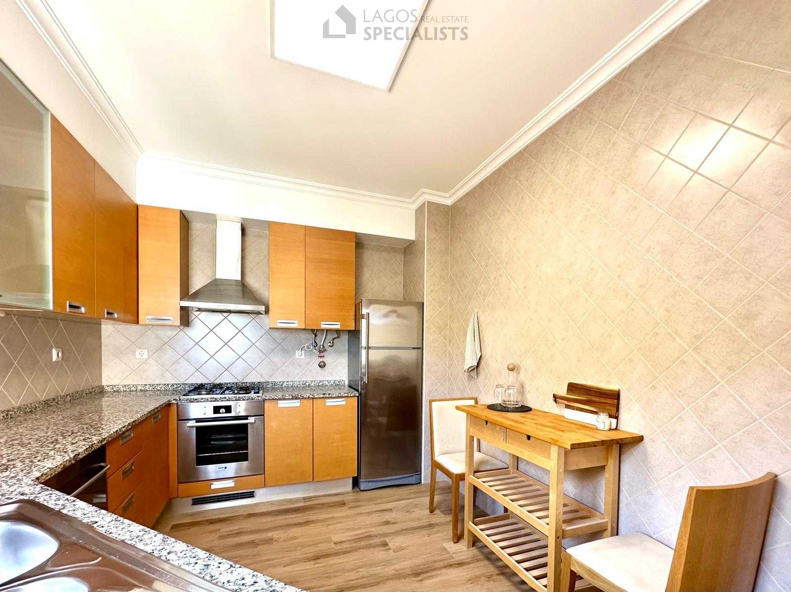 Fully equipped kitchen with stainless steel appliances and dining nook