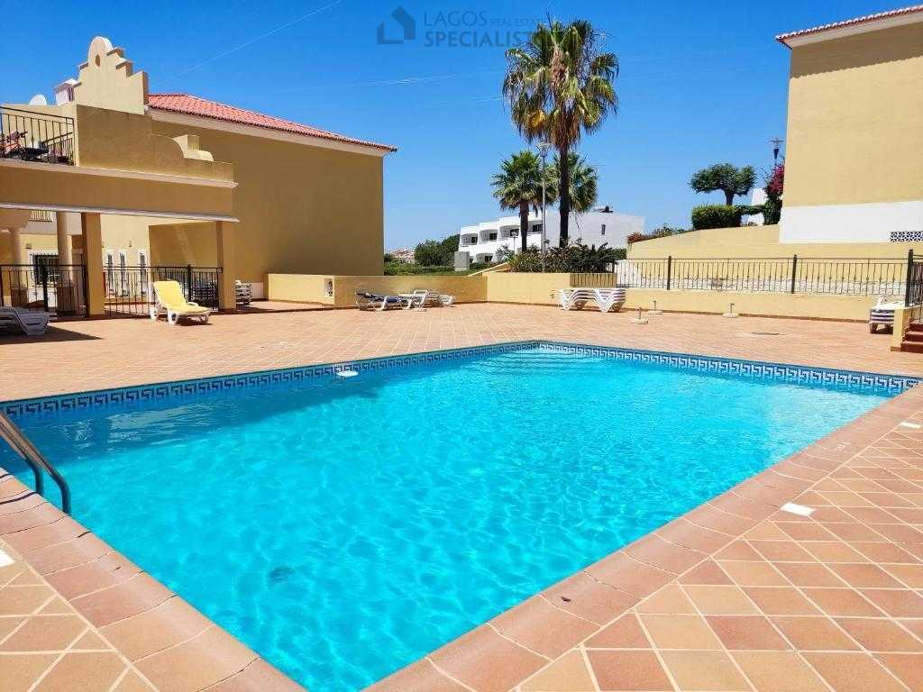 Family-friendly pool and garden area within gated condominium in Alporchinhos