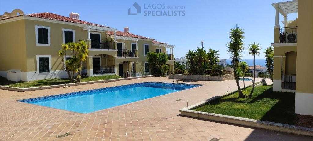 Condominium pool area with sea view and landscaped gardens in Alporchinhos Porches Algarve