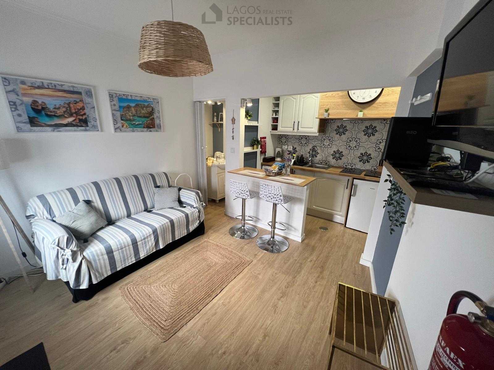 Cozy living area with sofa, TV and bar counter – house for sale in Lagos historic centre