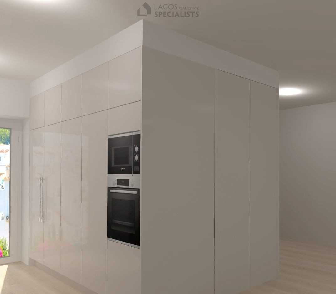 Sleek kitchen cabinets and integrated appliances in new Algarve home