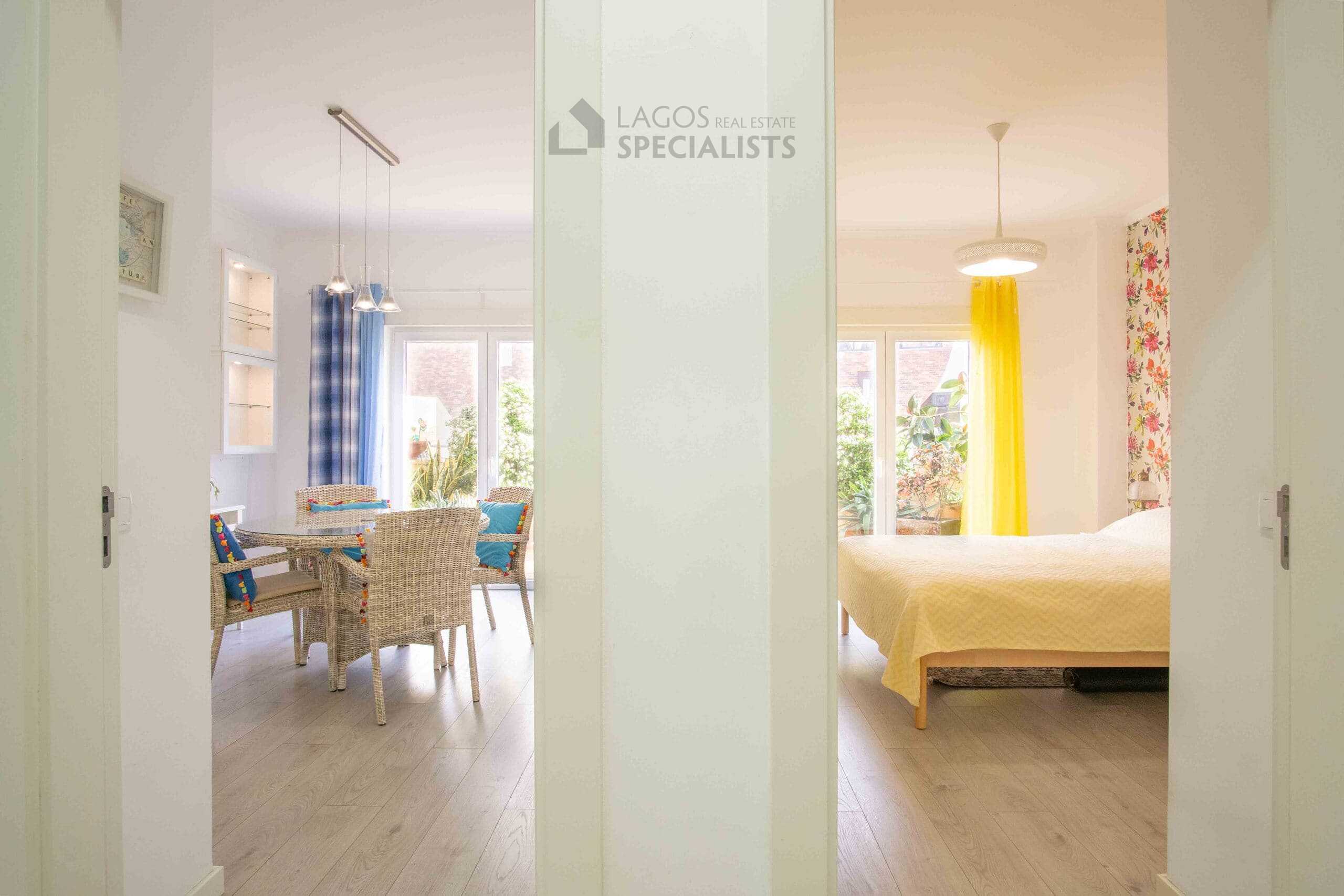 View through the hallway showing the connection between the living area and bedroom, highlighting the open and flowing layout of the Lagos apartment