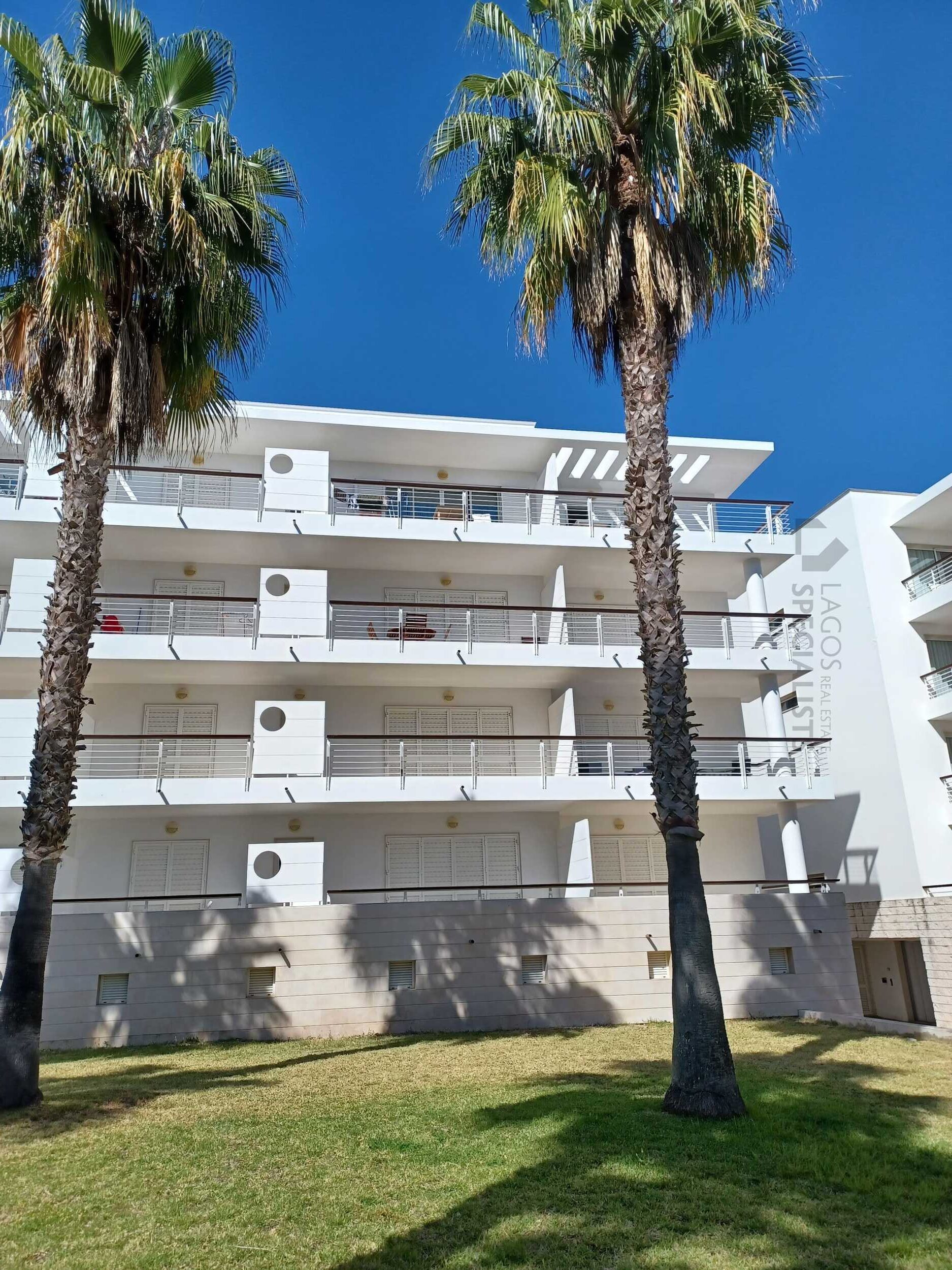 Exterior of secure marina condominium in prime Lagos Marina location with palm trees and modern architecture