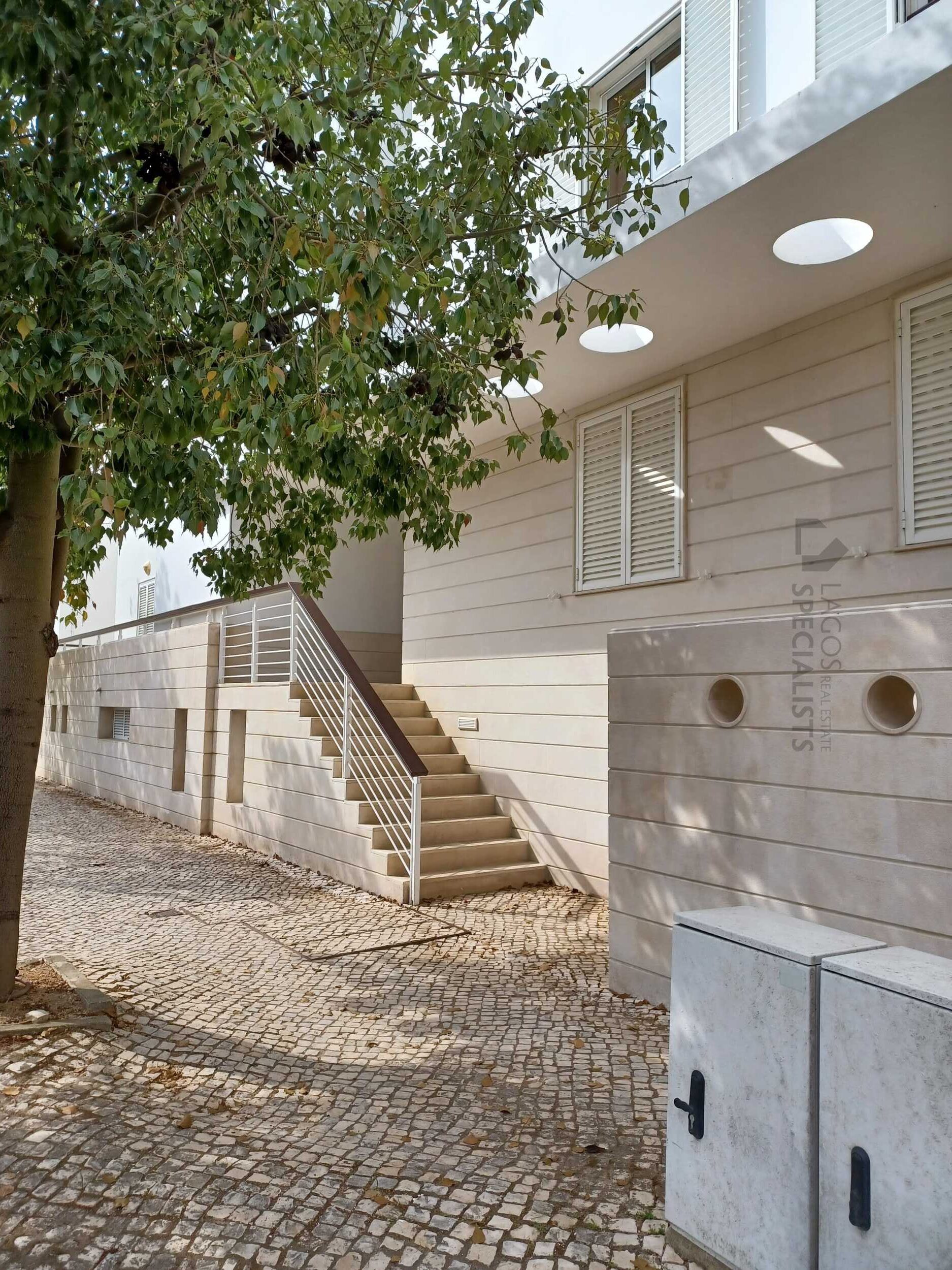 Exterior of secure marina condominium in prime Lagos Marina location with palm trees and modern architecture