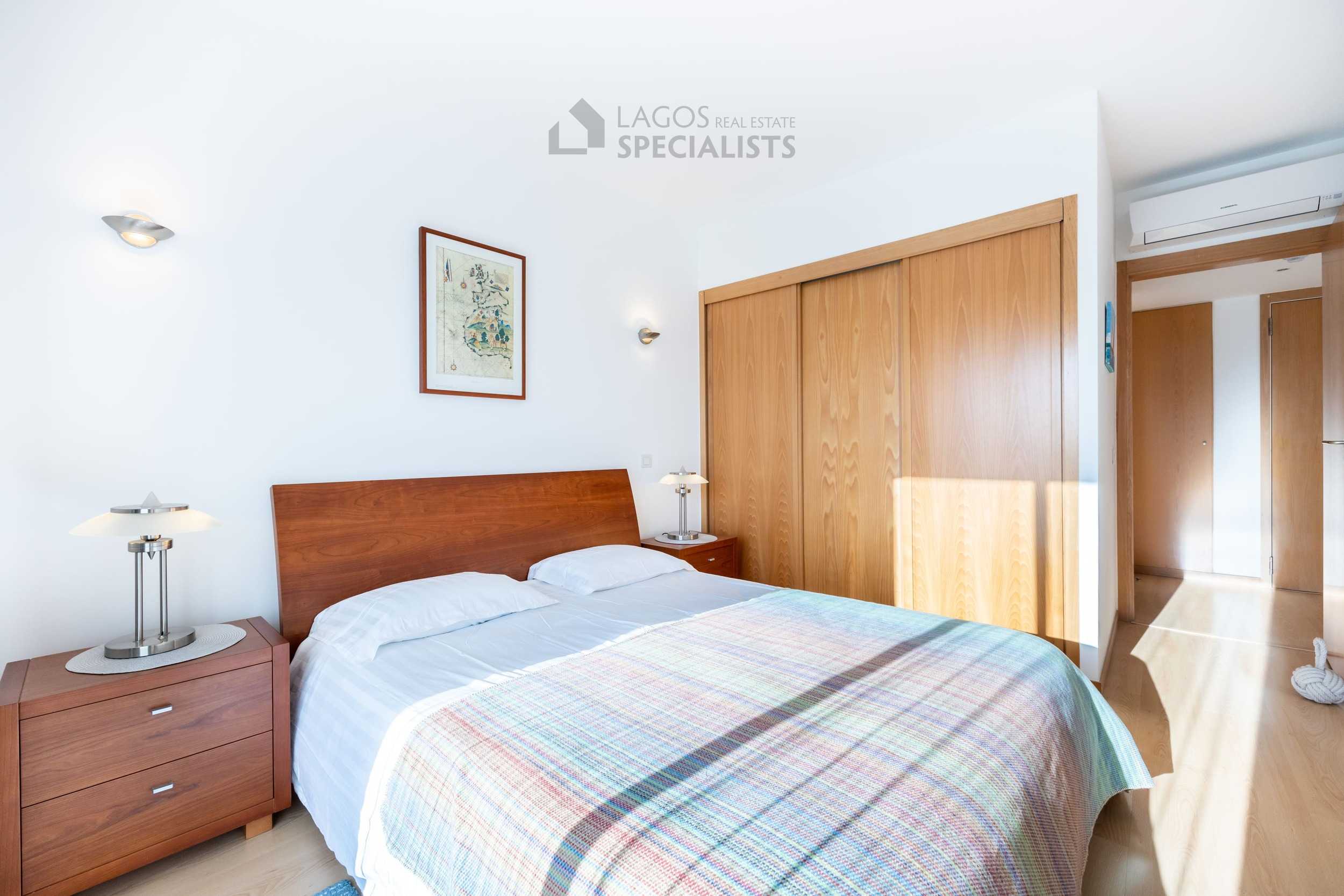 Bright sunny bedroom in premium Lagos Marina apartment with fitted wardrobes