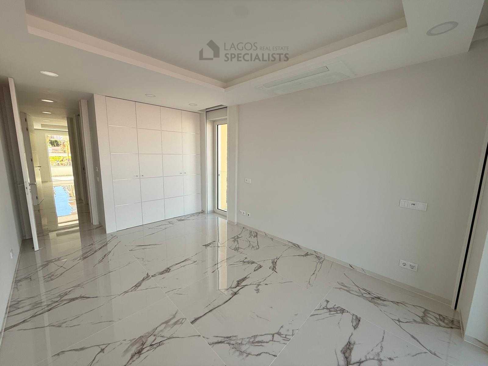 Bright bedroom with fitted wardrobes in luxury Lagos apartment near beach