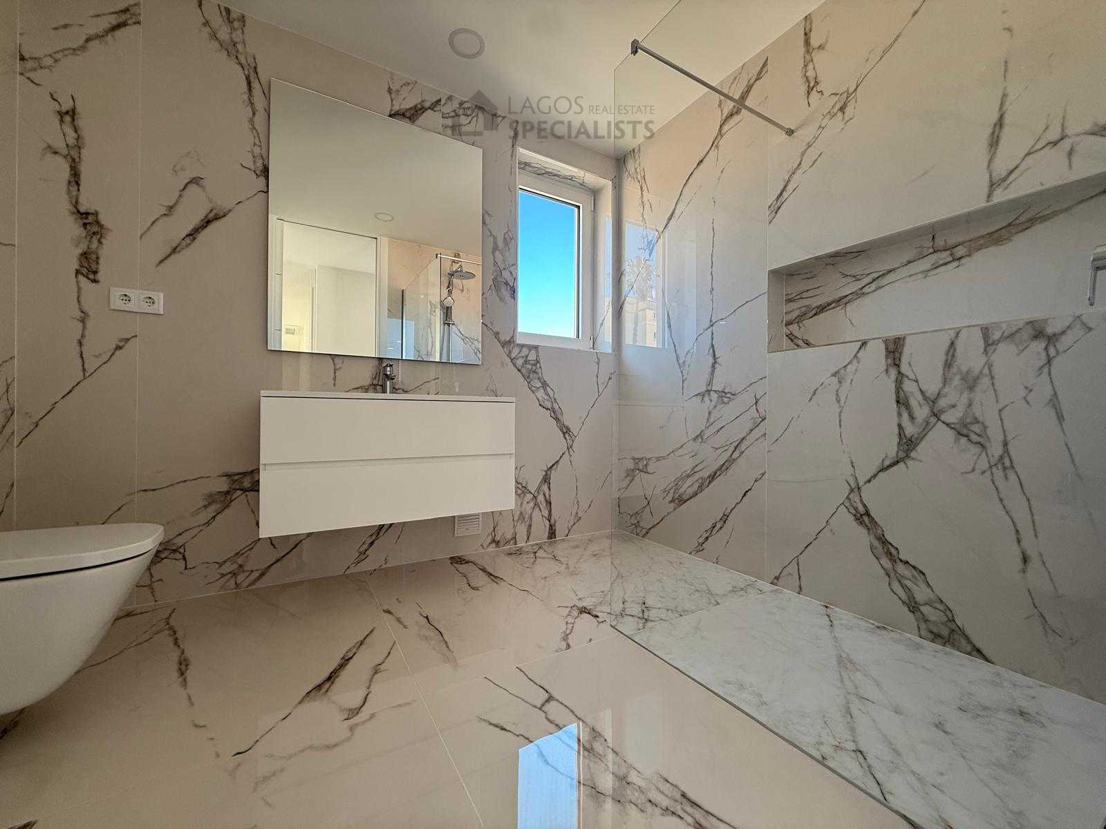 Modern marble-effect bathroom with walk-in shower in Lagos luxury apartment