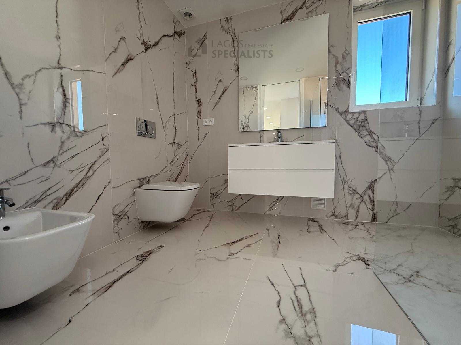 Modern marble-effect bathroom with walk-in shower in Lagos luxury apartment