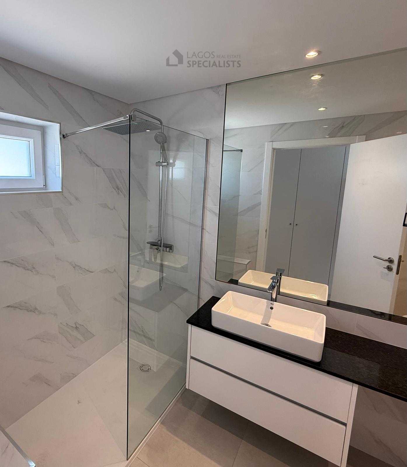 Sleek bathroom with walk-in shower