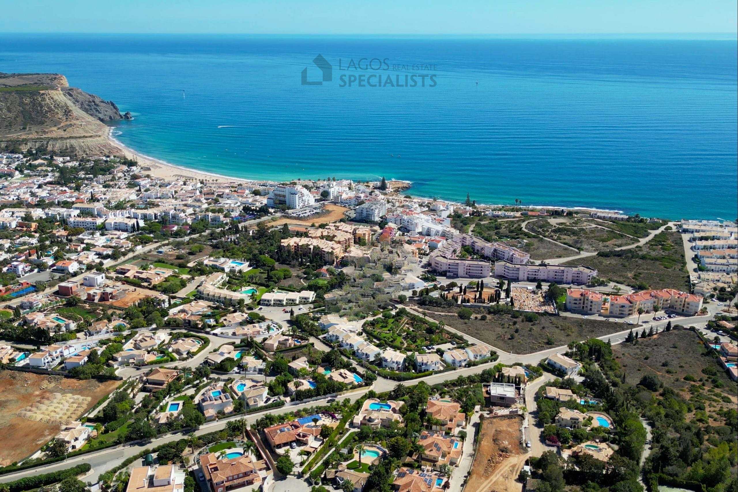 Elevated aerial view of Praia da Luz beach, town centre and surrounding residential neighbourhoods