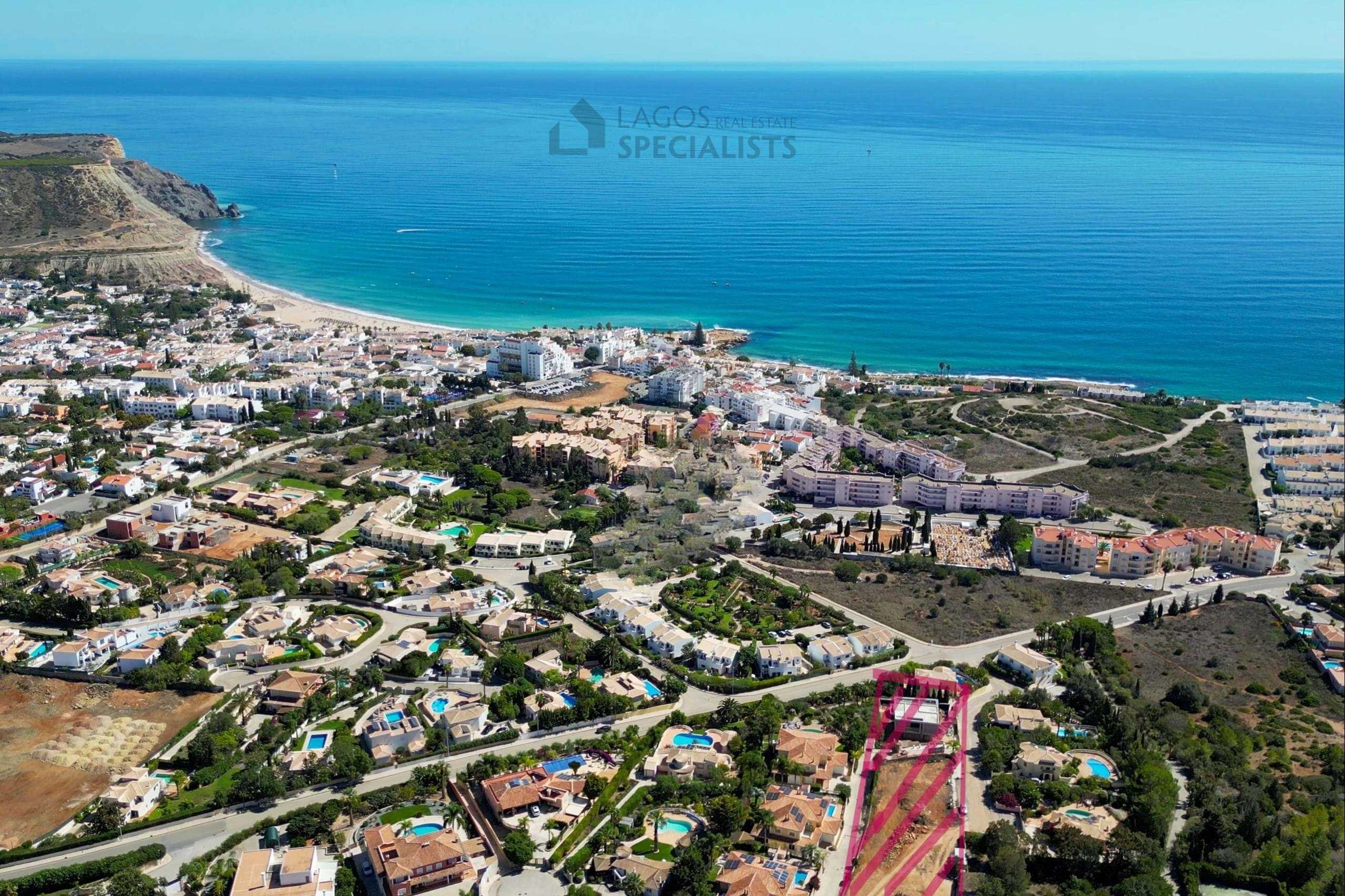 Aerial image of Praia da Luz with highlighted development plot near the coastline