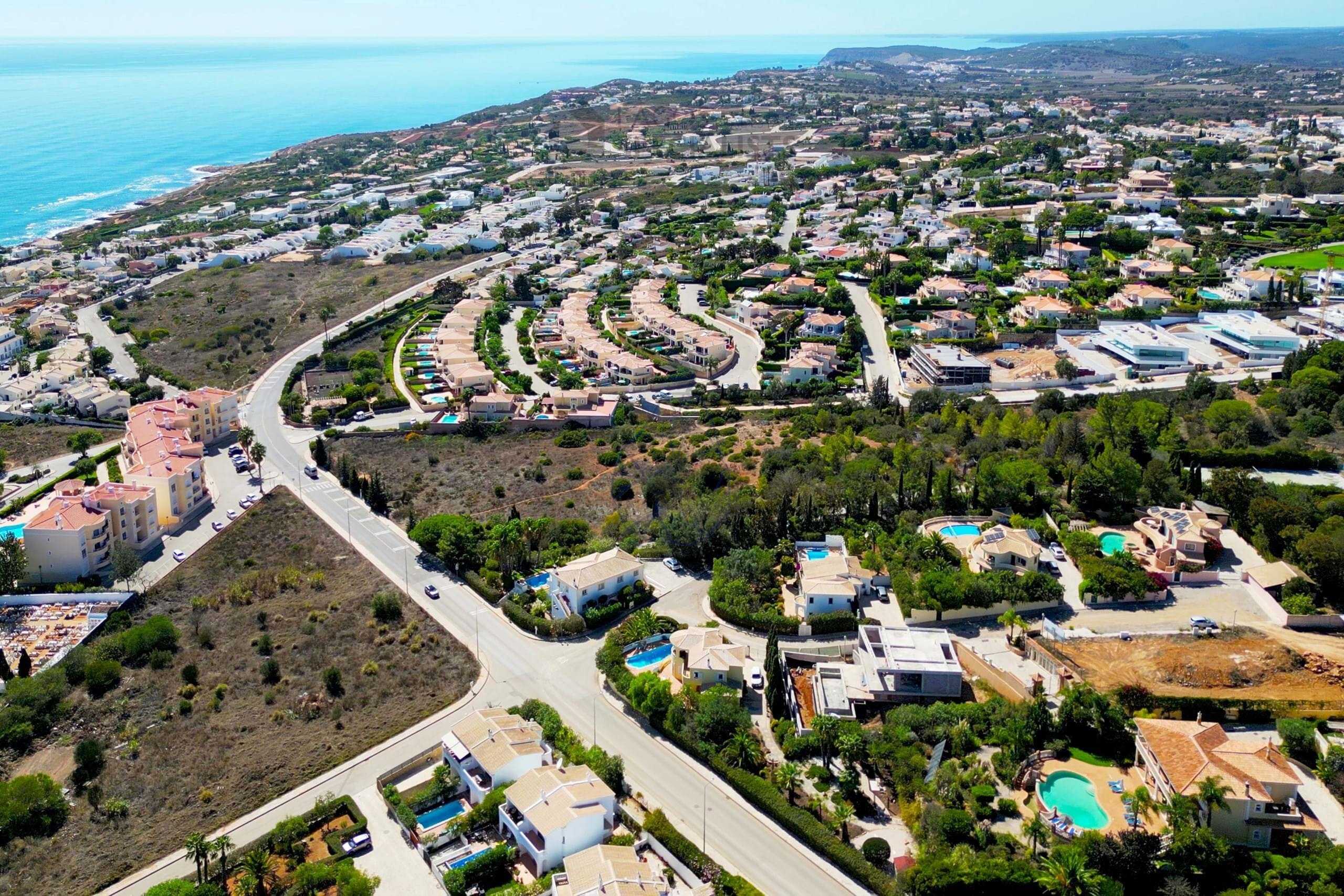 Aerial view of Praia da Luz beach and cliffs with residential buildings nearby