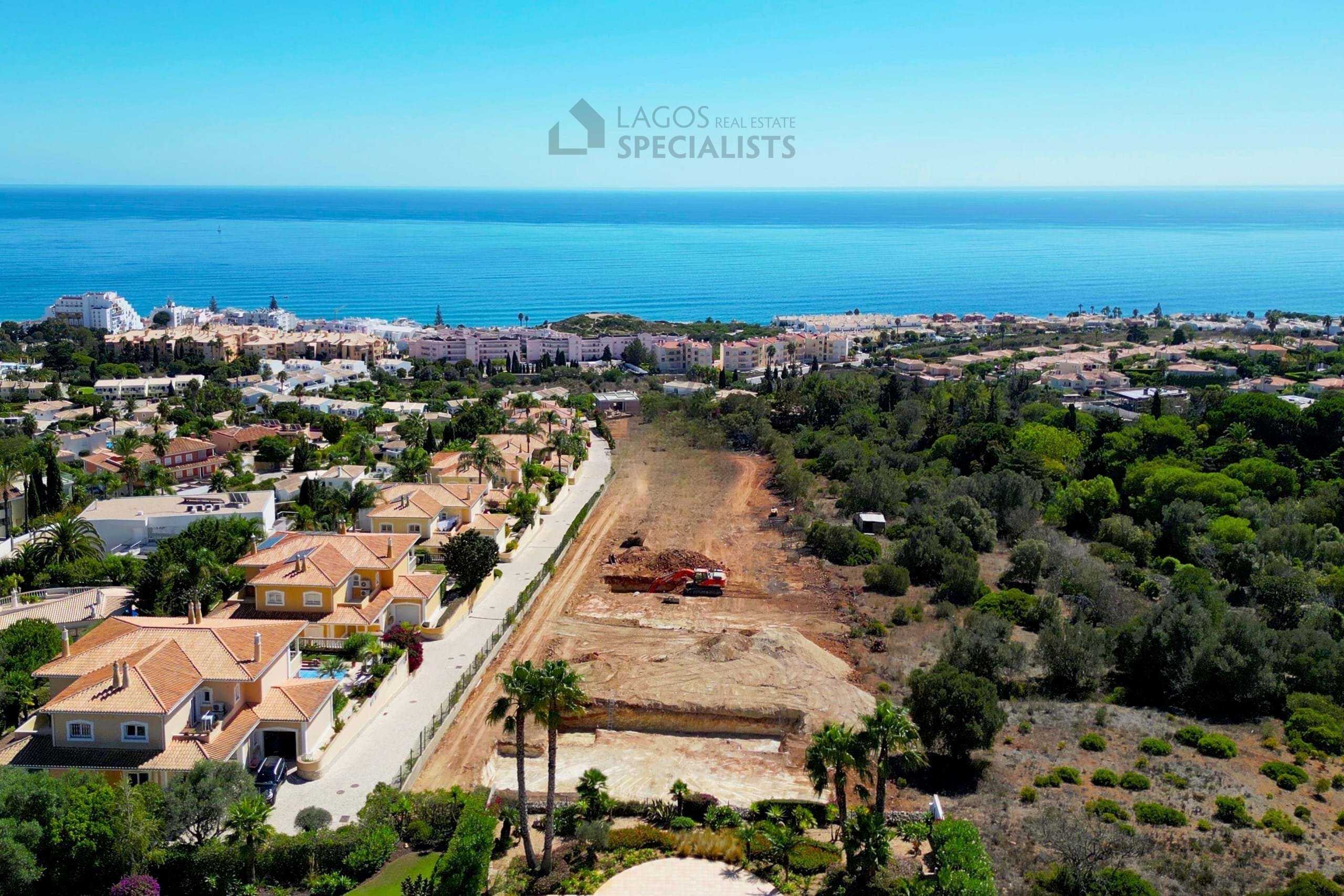 Elevated aerial of Praia da Luz residential area with sea views and coastal landscape