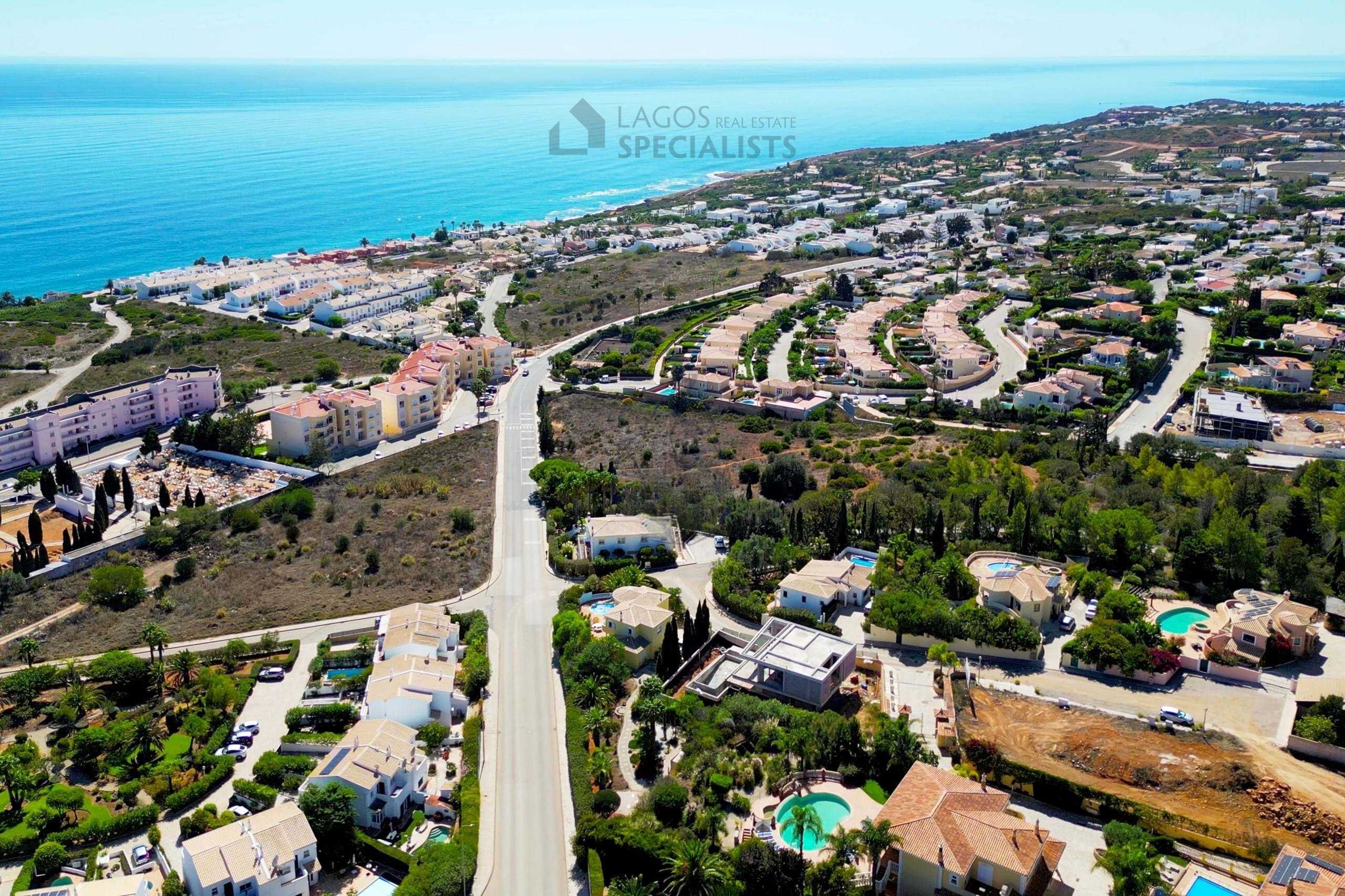 Aerial view of luxury villas and landscaped gardens near Praia da Luz beach