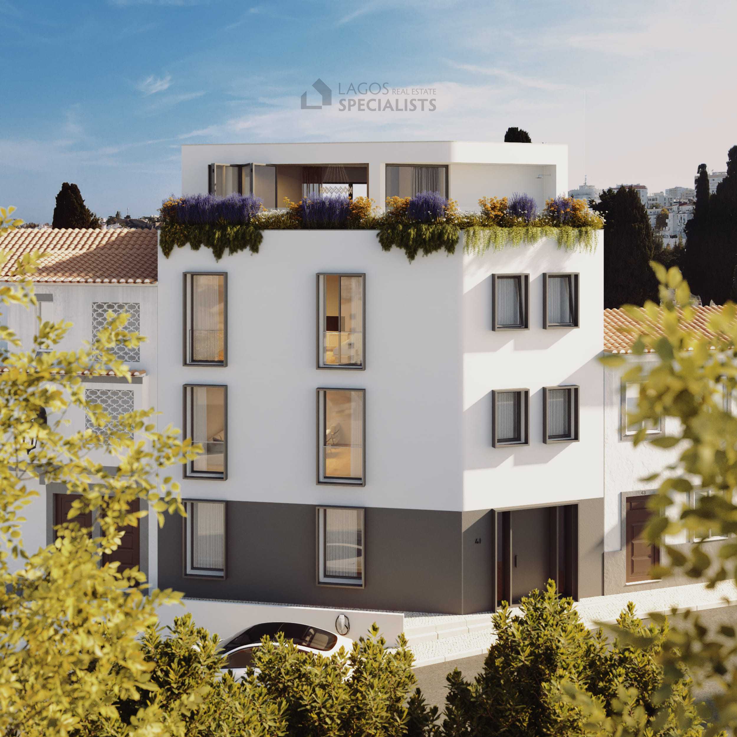 Exterior of boutique new build apartment building with white render and rooftop terrace, luxury 2-bedroom apartments and 3 bedroom penthouse for sale in central Lagos Algarve