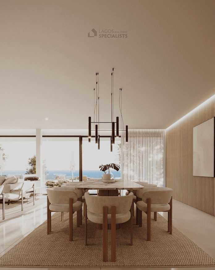 Interior render of building plot Praia da Luz showing dining area with ocean views through floor-to-ceiling windows